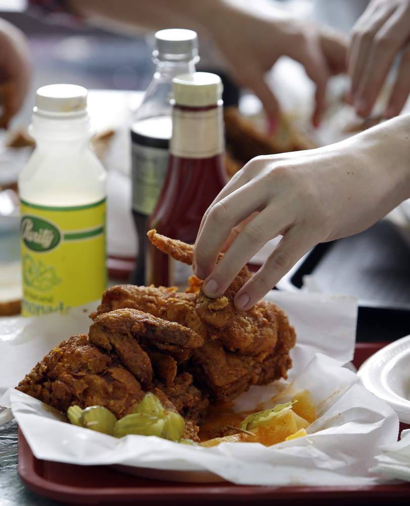 Reaching for some hot chicken at Prince&#39;s Hot Chicken Shack. Mark Humphrey\/AP